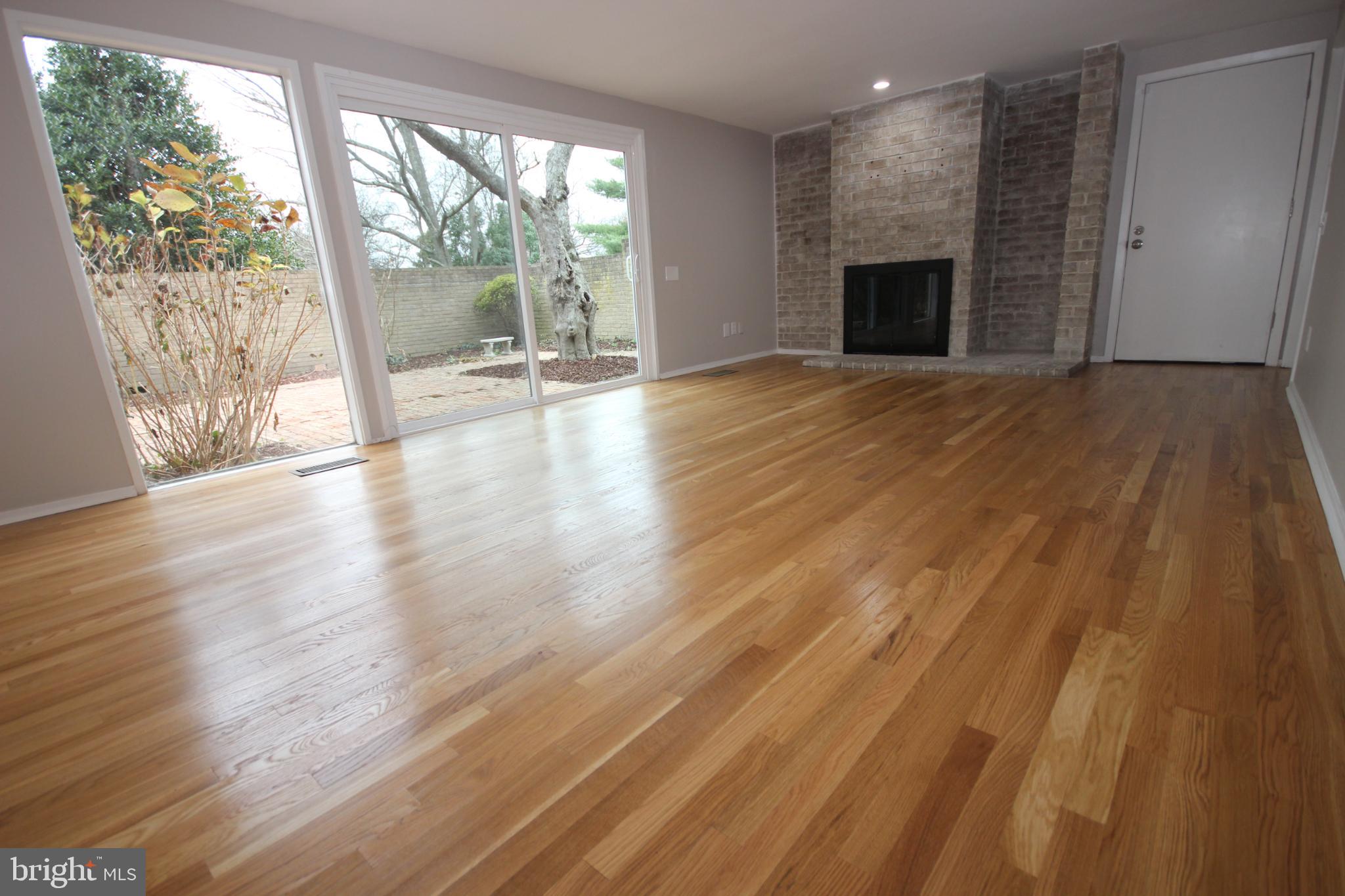 19115 Roman Way Montgomery Village, MD 20886 - Photo 14 of 67 a view of empty room with wooden floor and fireplace
