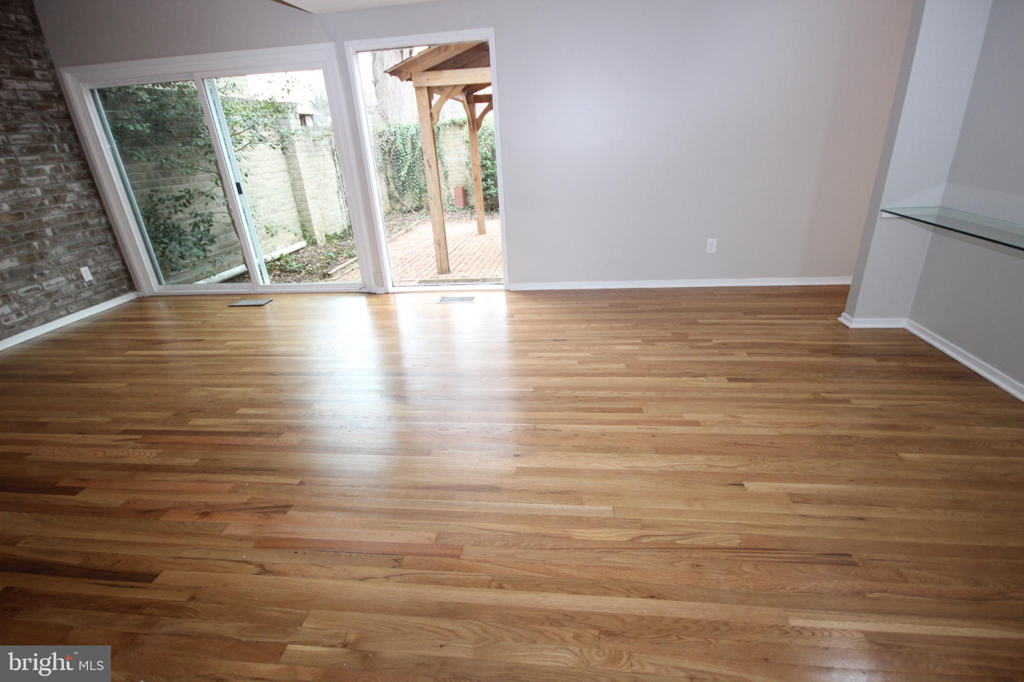 19115 Roman Way Montgomery Village, MD 20886 - Photo 22 of 67 a view of an empty room with wooden floor and a window