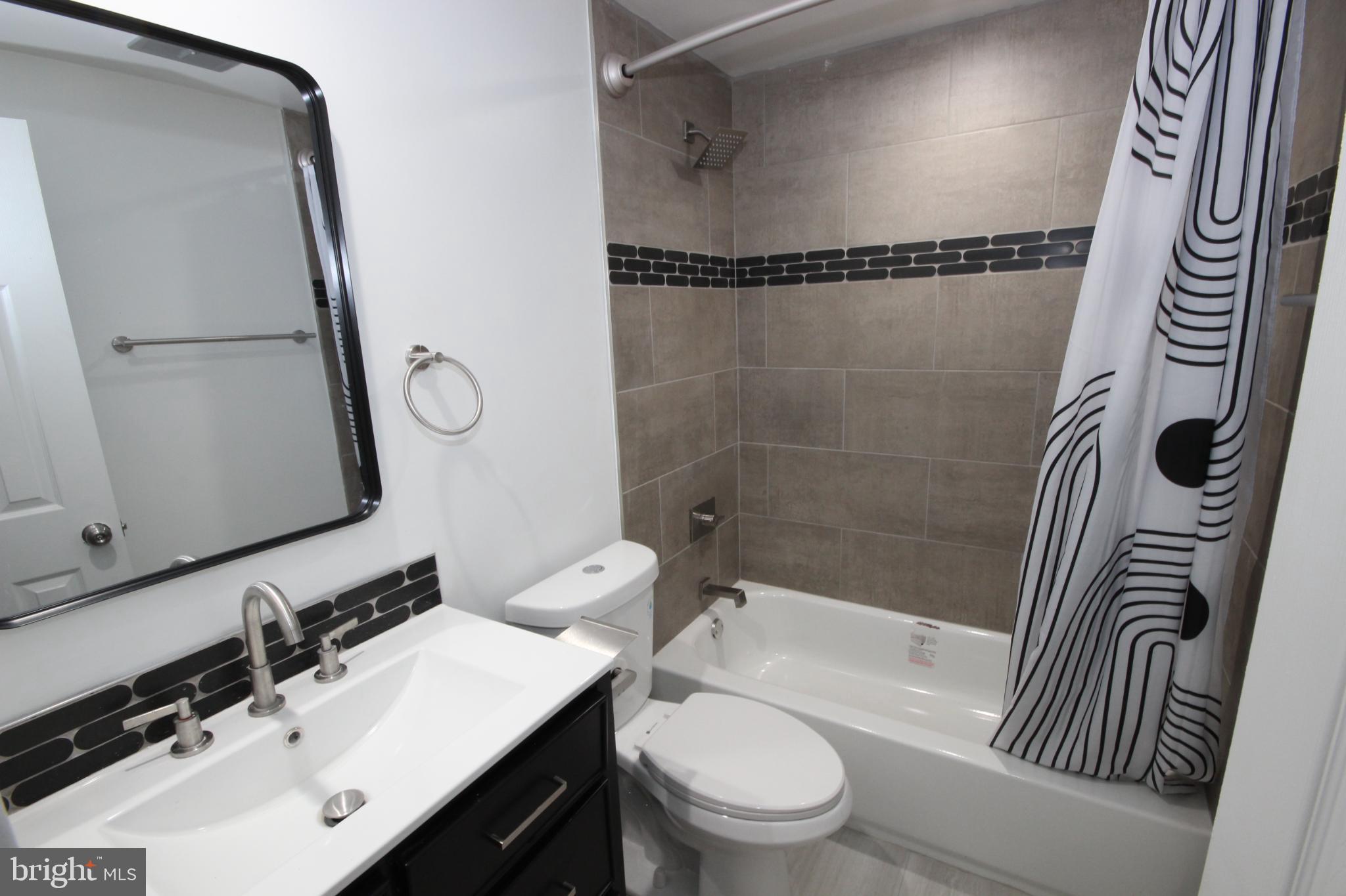 19115 Roman Way Montgomery Village, MD 20886 - Photo 24 of 67 a bathroom with a sink a toilet and a mirror