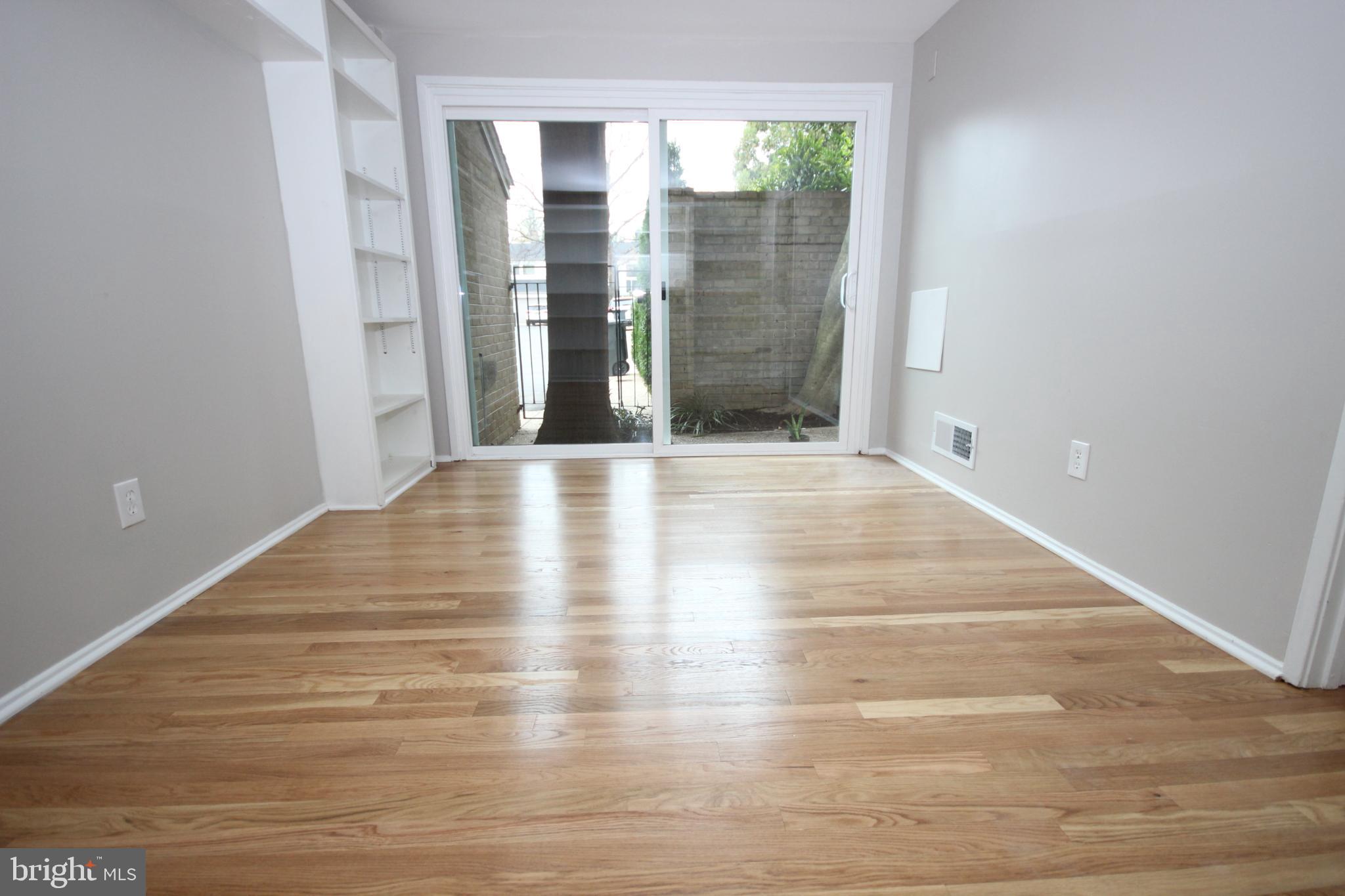 19115 Roman Way Montgomery Village, MD 20886 - Photo 25 of 67 a view of an empty room with wooden floor and a window