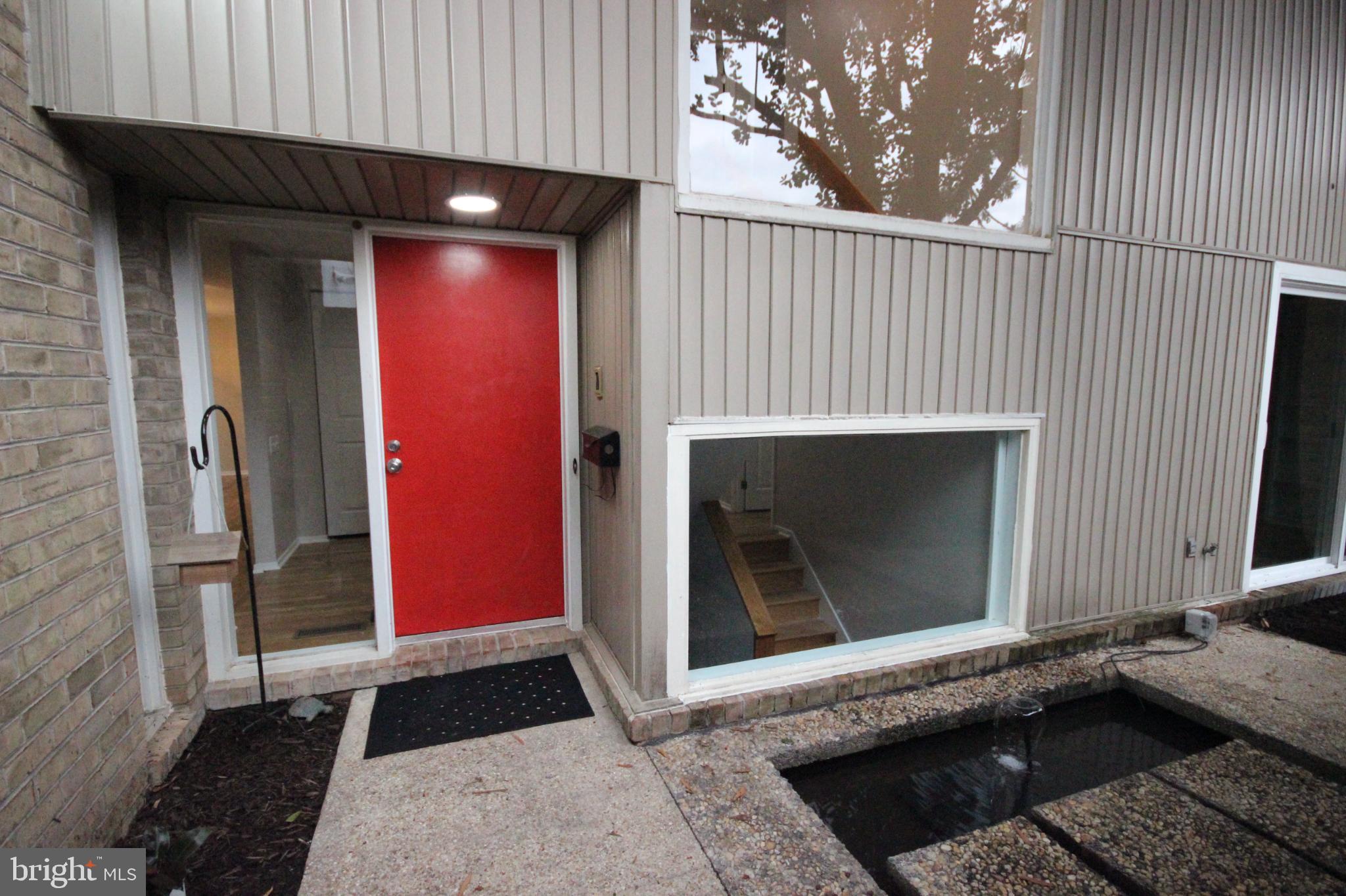 19115 Roman Way Montgomery Village, MD 20886 - Photo 27 of 67 a living room with a fireplace and a rug
