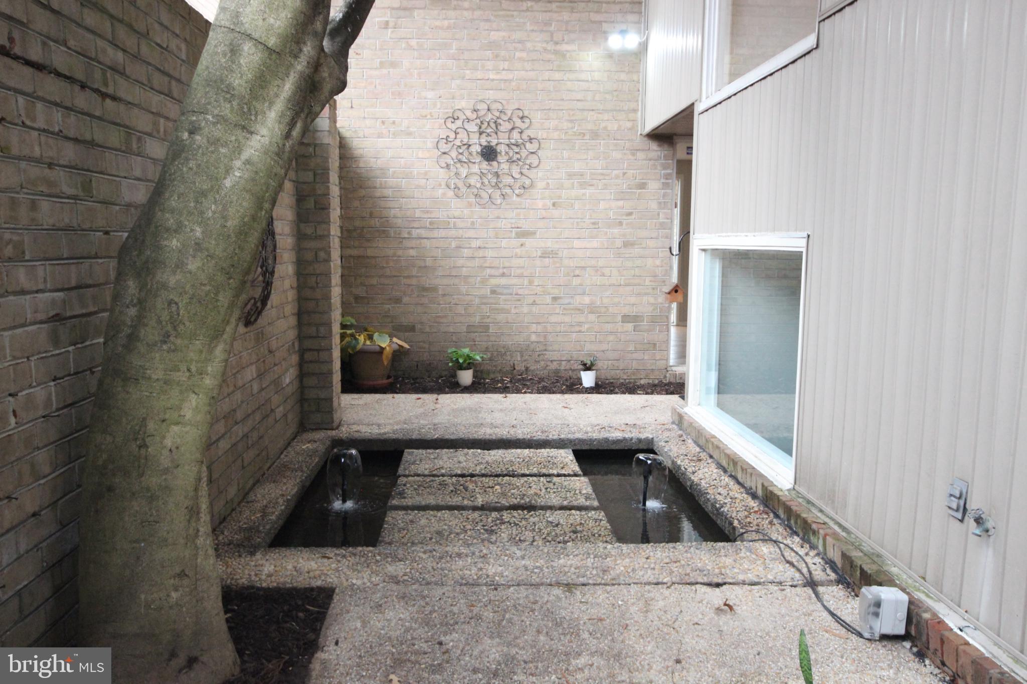 19115 Roman Way Montgomery Village, MD 20886 - Photo 28 of 67 Tranquil courtyard entrance w/serene water feature