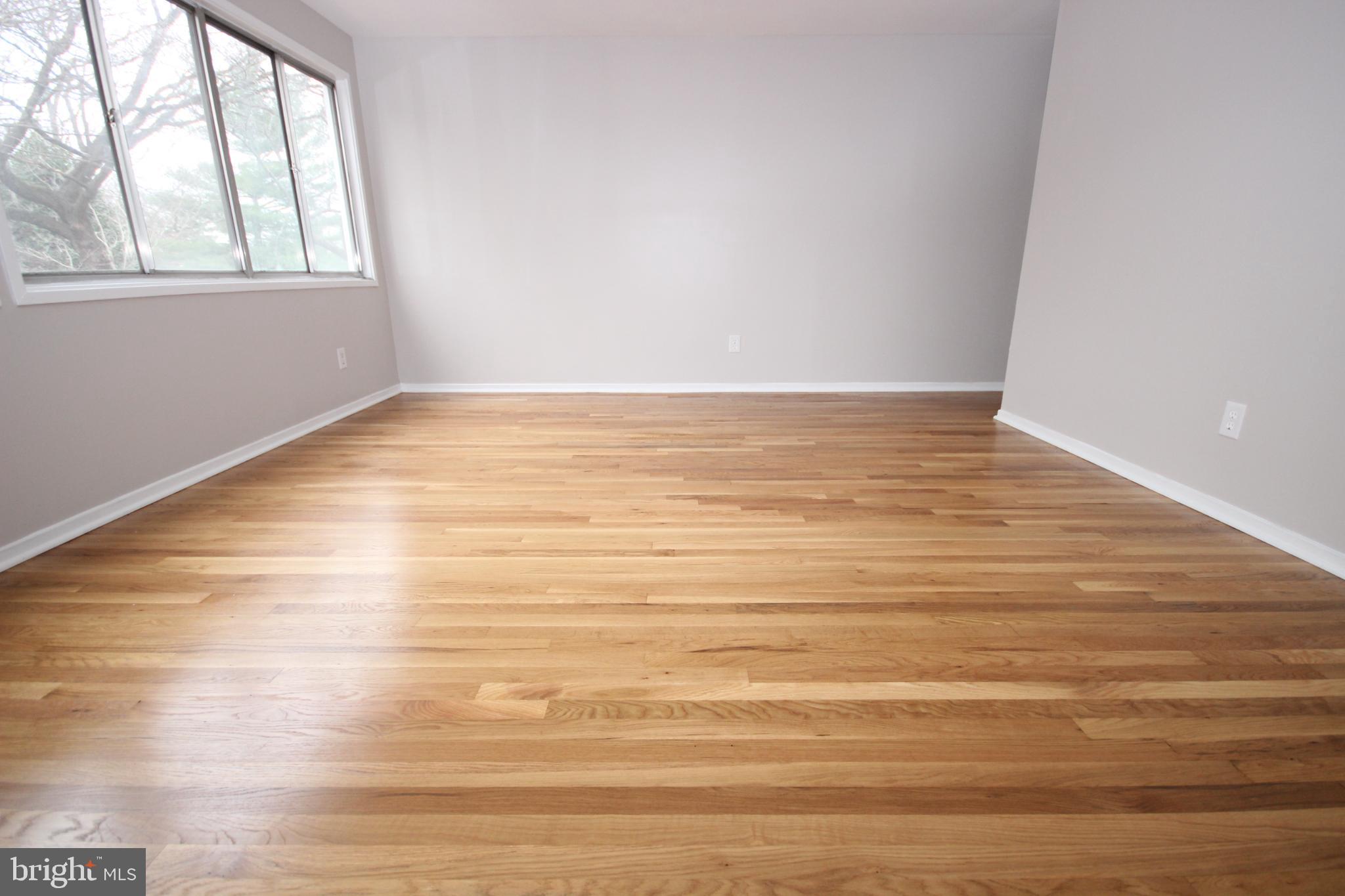 19115 Roman Way Montgomery Village, MD 20886 - Photo 33 of 67 a view of an empty room with wooden floor and windows