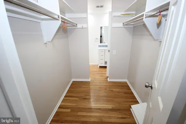 a view of a room with wooden floor and a window