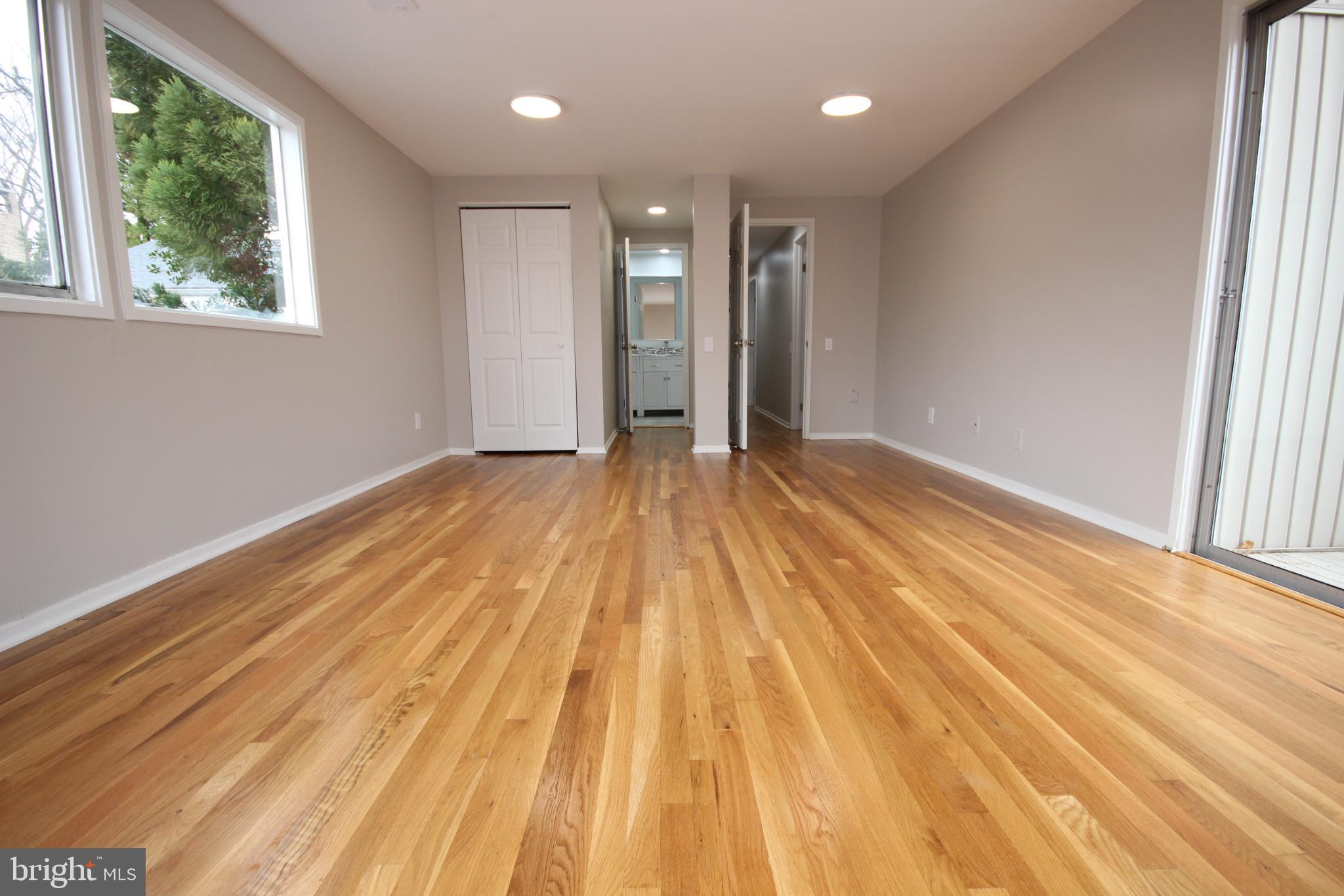 19115 Roman Way Montgomery Village, MD 20886 - Photo 38 of 67 a view of an empty room with wooden floor and a window