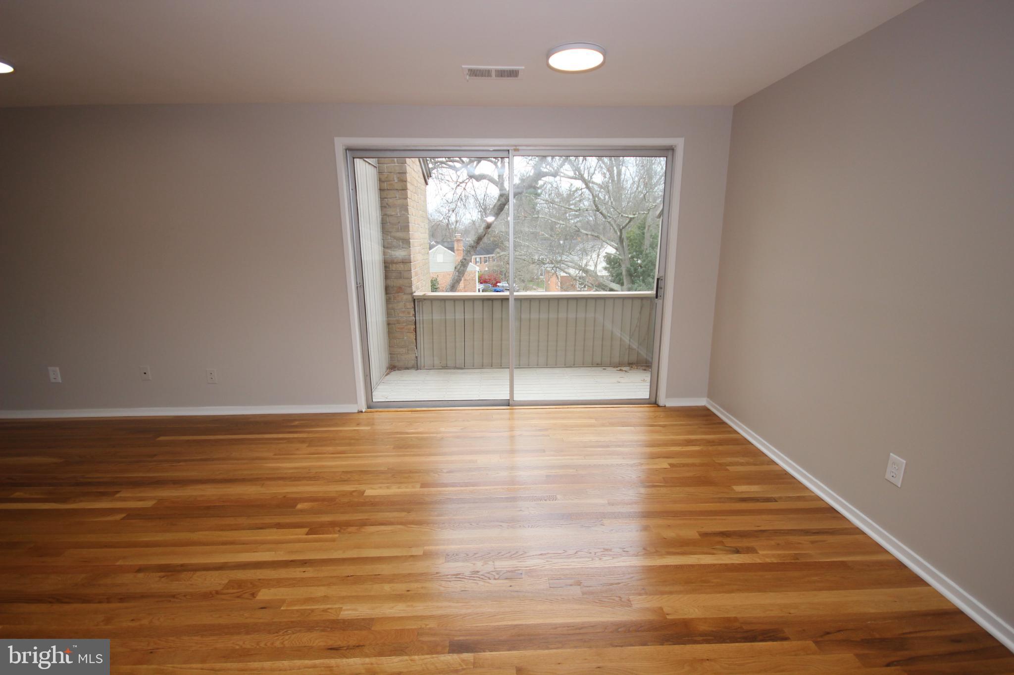 19115 Roman Way Montgomery Village, MD 20886 - Photo 40 of 67 a view of empty room with wooden floor and fan