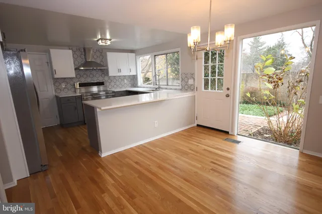 a kitchen with a refrigerator stove and white cabinets