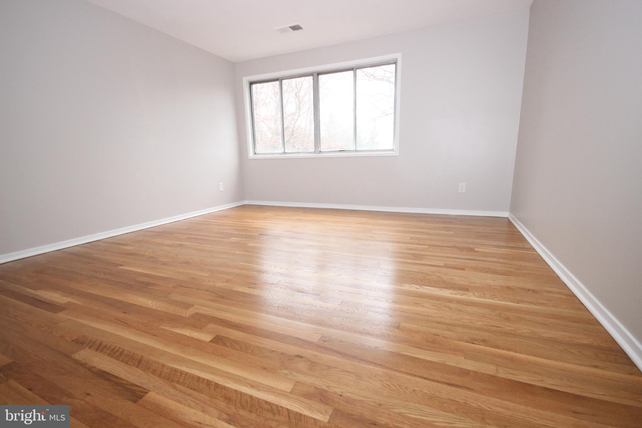 19115 Roman Way Montgomery Village, MD 20886 - Photo 41 of 67 an empty room with wooden floor and windows