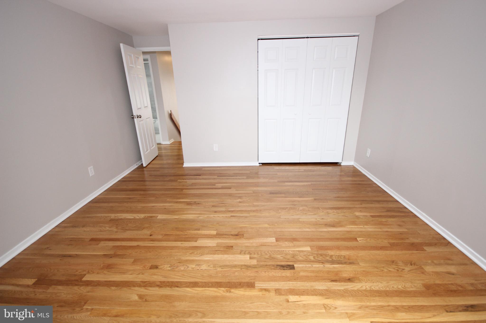 19115 Roman Way Montgomery Village, MD 20886 - Photo 44 of 67 a view of an empty room with wooden floor