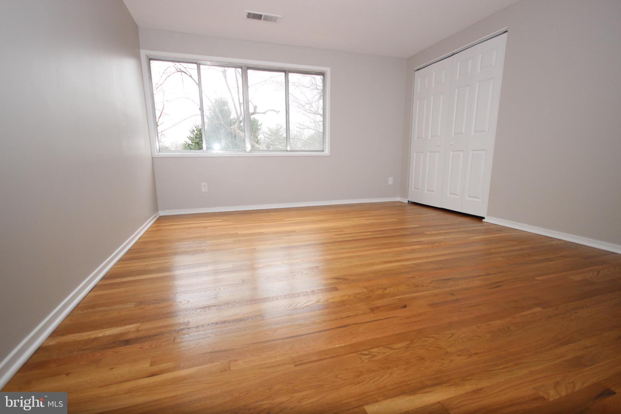 19115 Roman Way Montgomery Village, MD 20886 - Photo 46 of 67 an empty room with wooden floor and windows