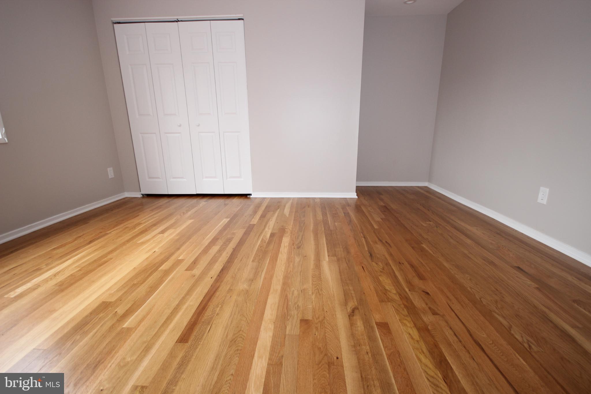 19115 Roman Way Montgomery Village, MD 20886 - Photo 47 of 67 a view of an empty room with wooden floor