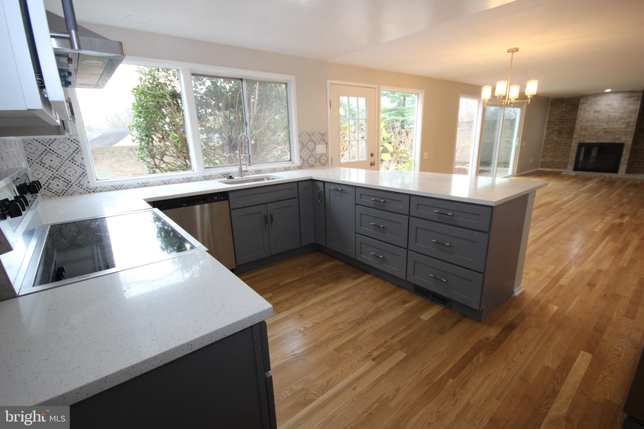 19115 Roman Way Montgomery Village, MD 20886 - Photo 5 of 67 a kitchen with stainless steel appliances kitchen island granite countertop a sink a counter space and a large window