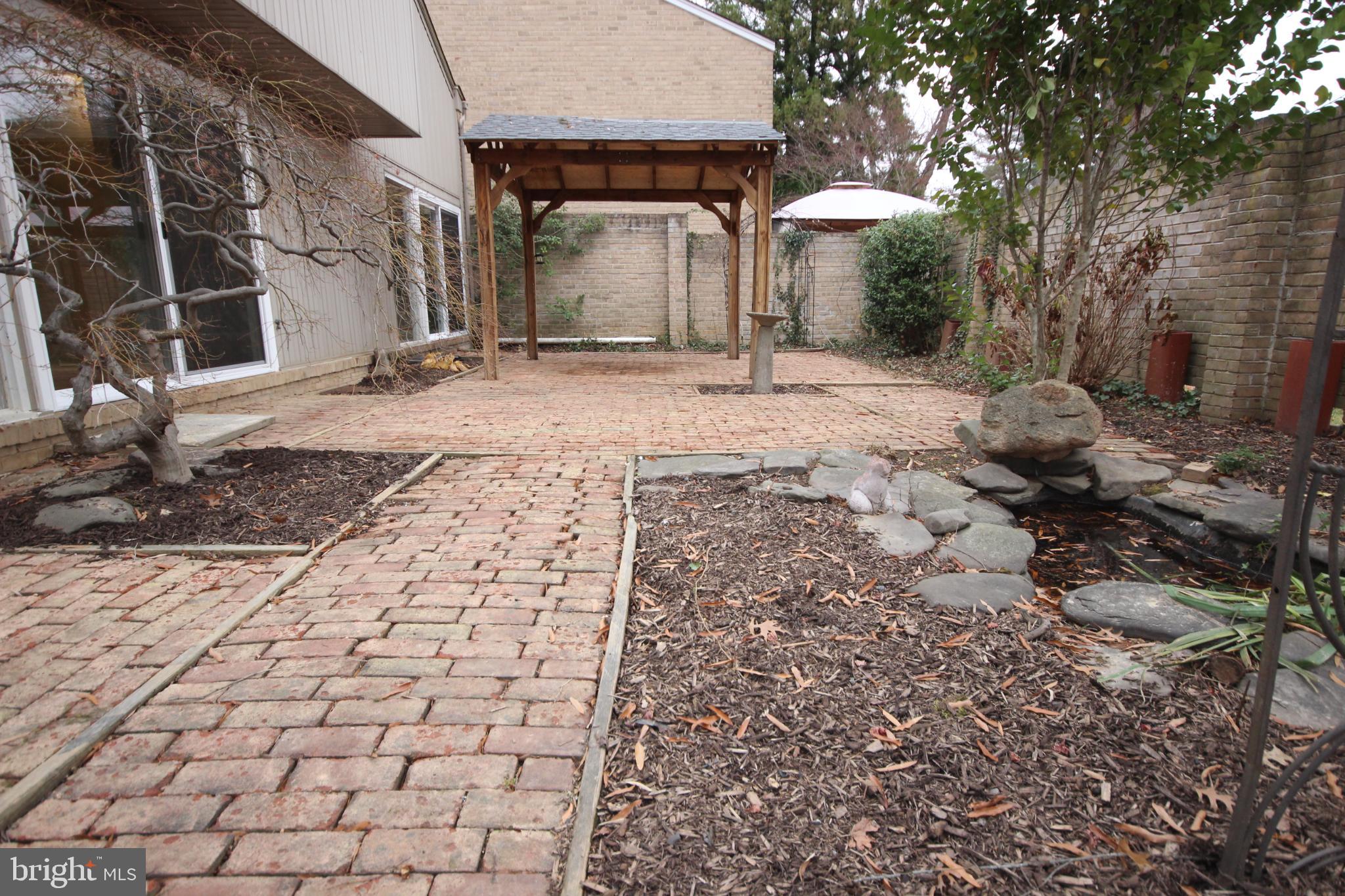 19115 Roman Way Montgomery Village, MD 20886 - Photo 53 of 67 Tranquil garden retreat with stone pathways.