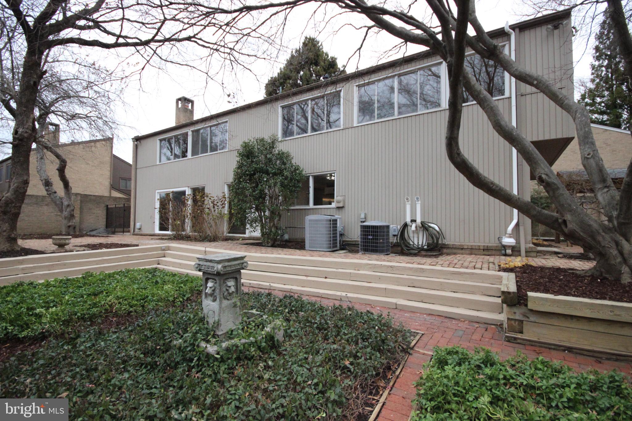 19115 Roman Way Montgomery Village, MD 20886 - Photo 56 of 67 a view of a white house with a small yard and a large tree