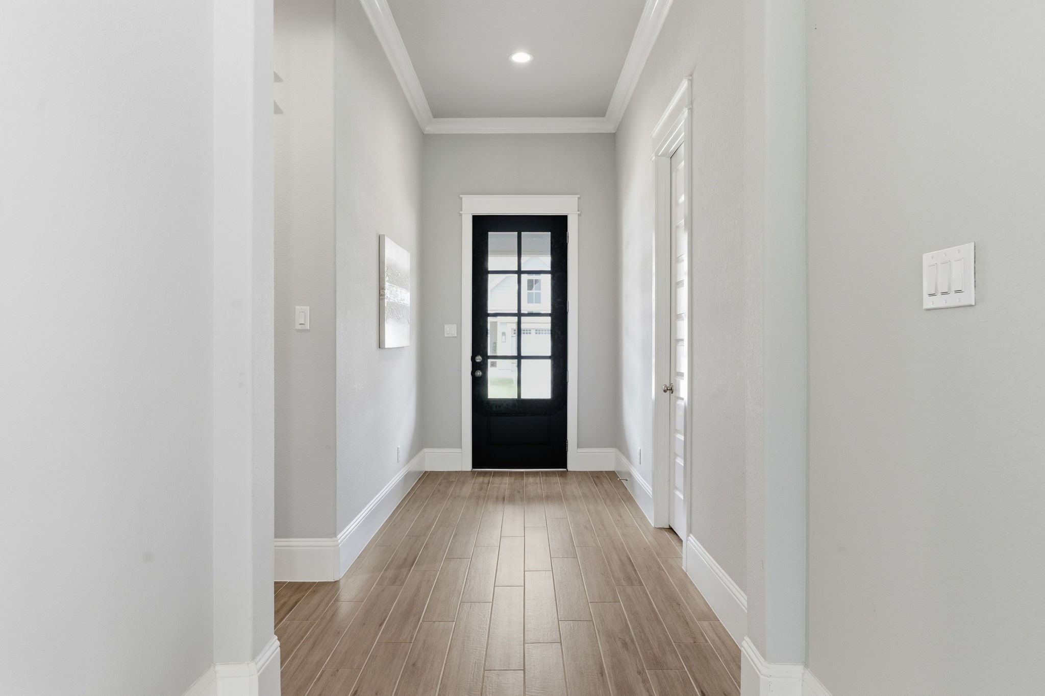 2208 Salt Grass Trail Conroe, TX 77384 - Photo 34 of 34 The tall ceilings, trimmed in ceiling moldings and tall floor moldings offer a grand and spacious entrance into the 2 secondary bedroom suites towards the front of this floorplan.