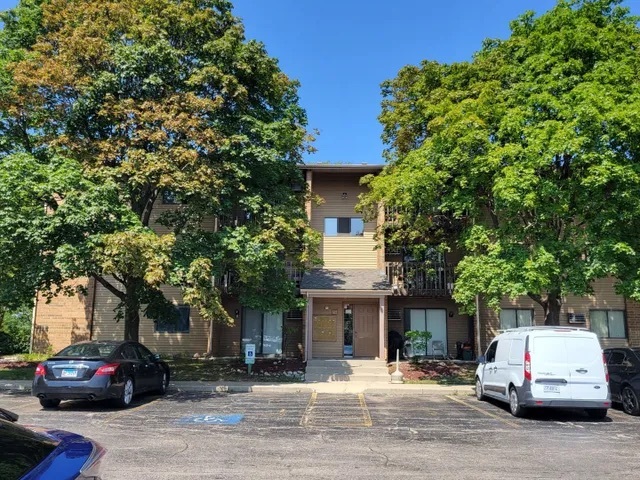 627 South Virginia Road, Unit 312 Crystal Lake, IL 60014 - Photo 1 of 13 a car parked in front of a house