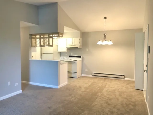 627 South Virginia Road, Unit 312 Crystal Lake, IL 60014 - Photo 3 of 13 a kitchen with kitchen island stainless steel appliances a window and a chandelier