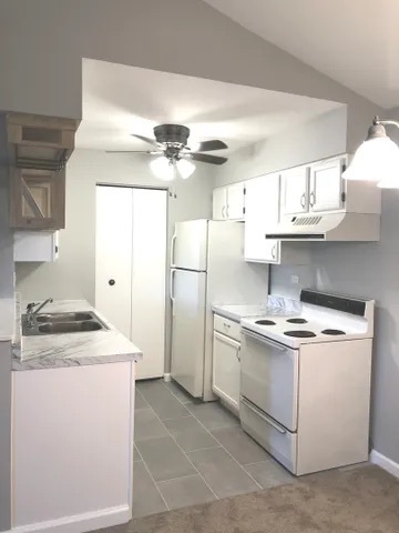627 South Virginia Road, Unit 312 Crystal Lake, IL 60014 - Photo 6 of 13 a kitchen with stainless steel appliances granite countertop a sink stove a refrigerator and white cabinets