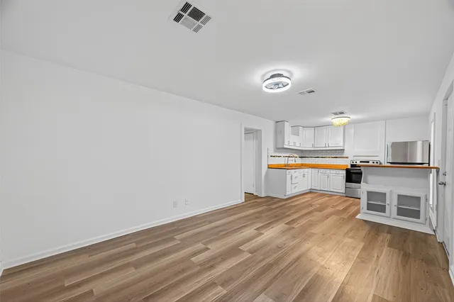 a view of kitchen with wooden floor and electronic appliances