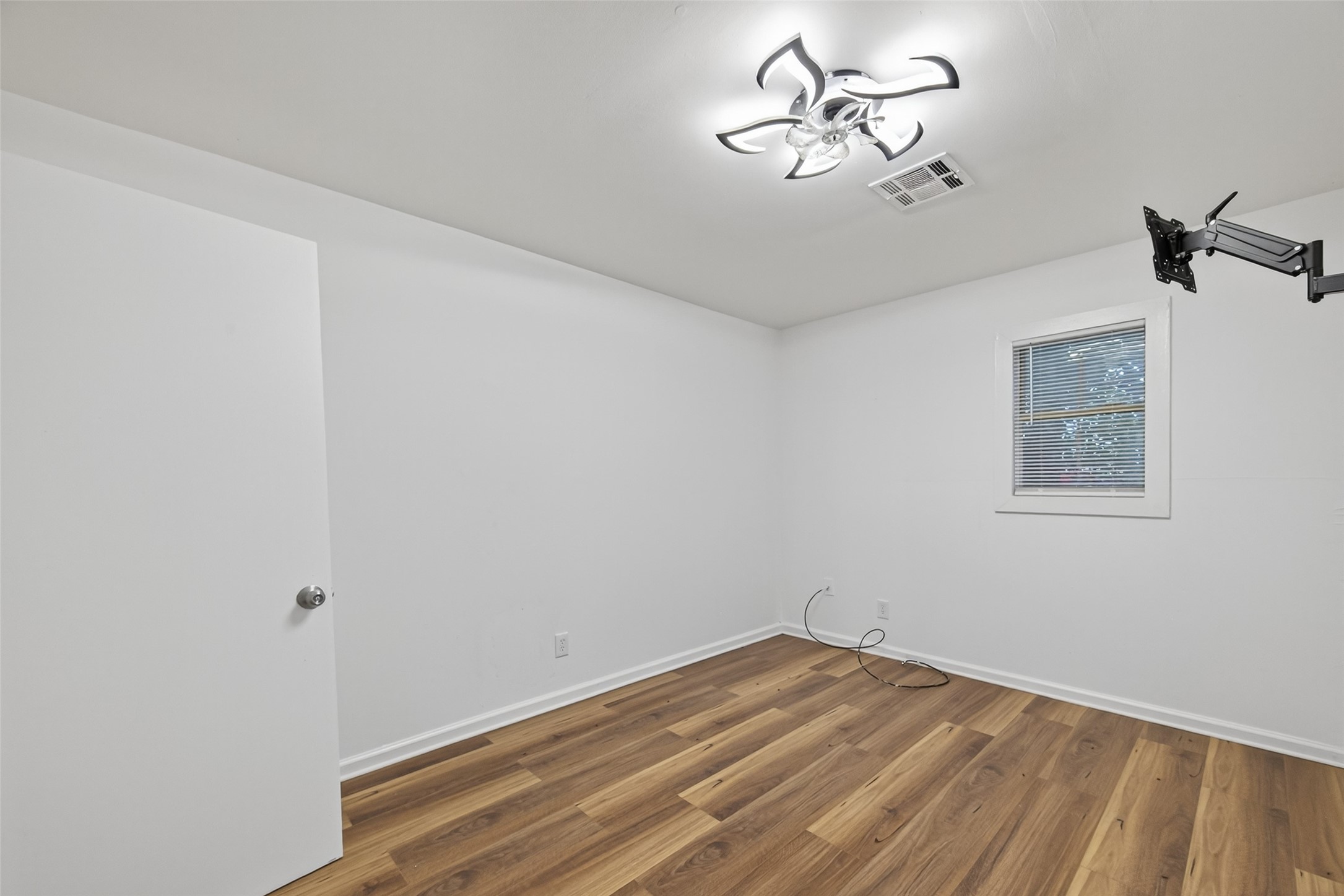 105 Clear Lake Road, Unit A Highlands, TX 77562 - Photo 13 of 25 a view of a room with a hanging light and hardwood floor