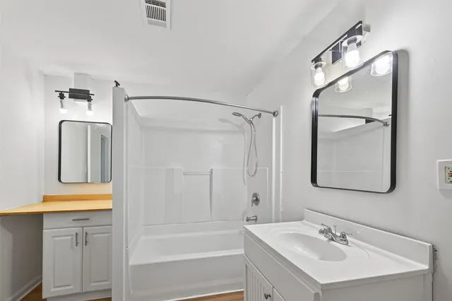 a bathroom with a sink a mirror and a shower
