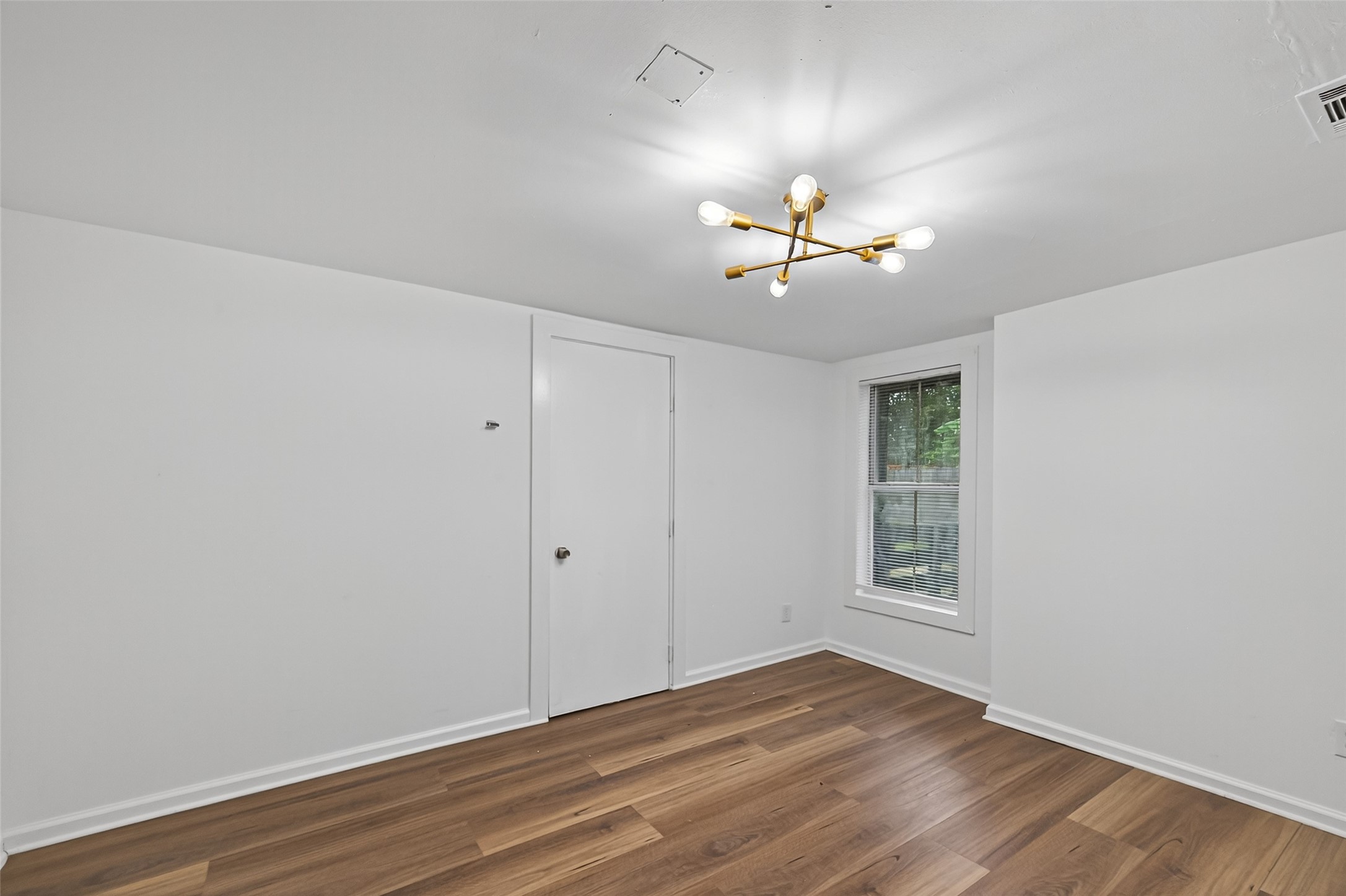 105 Clear Lake Road, Unit A Highlands, TX 77562 - Photo 18 of 25 wooden floor in an empty room with a window