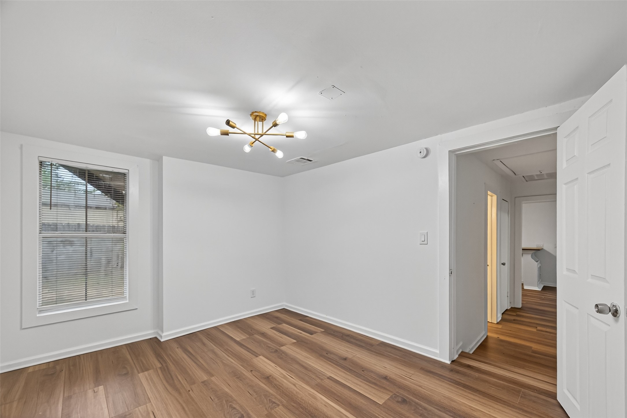 105 Clear Lake Road, Unit A Highlands, TX 77562 - Photo 20 of 25 a view of an empty room with wooden floor and a window