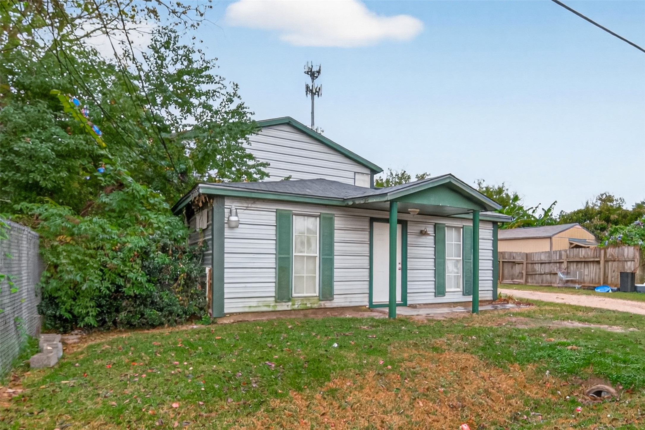 105 Clear Lake Road, Unit A Highlands, TX 77562 - Photo 3 of 25 a front view of a house with a garden