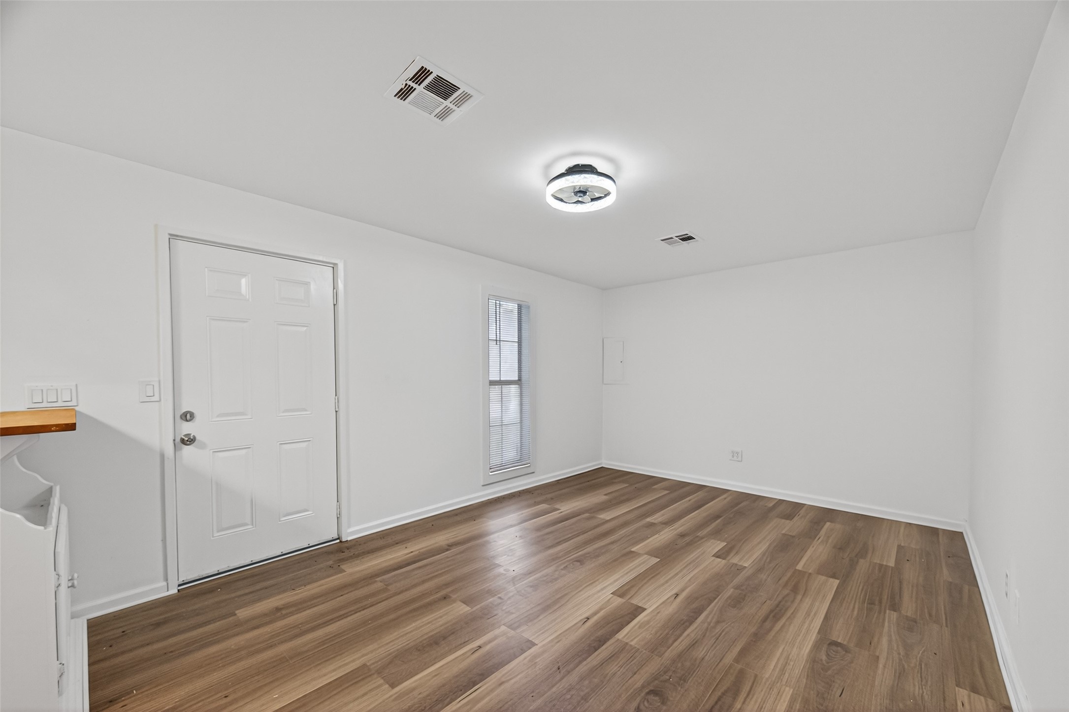 105 Clear Lake Road, Unit A Highlands, TX 77562 - Photo 8 of 25 a view of an empty room with wooden floor and a window
