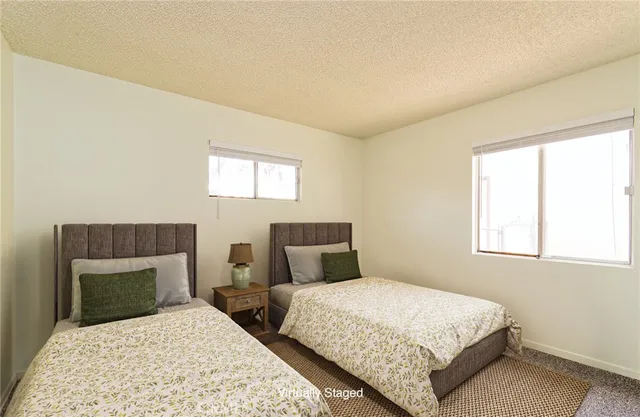 a bedroom with two beds and a window