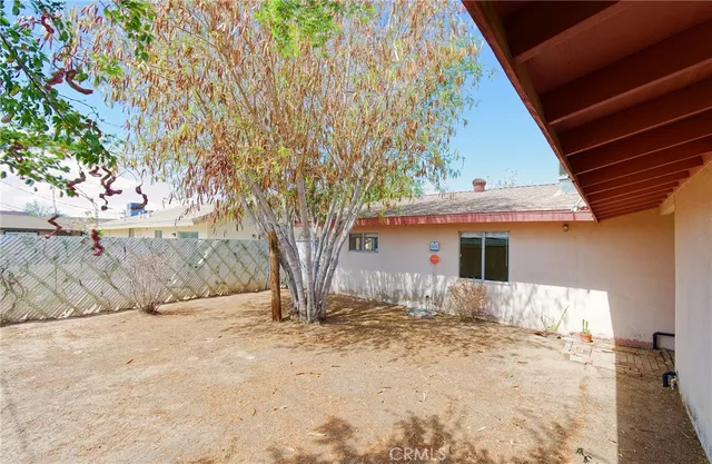 a backyard of a house with large trees