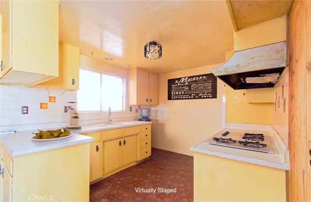 a kitchen with a stove a sink and a refrigerator
