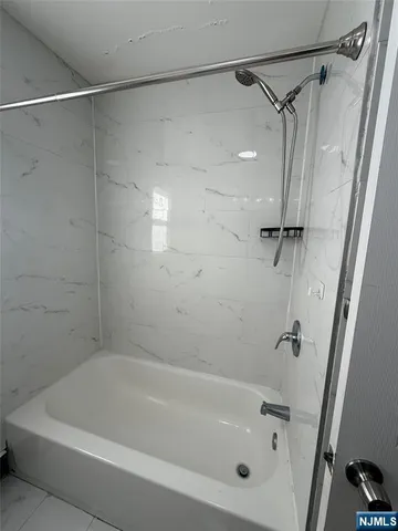 a bathroom with a bathtub and a shower