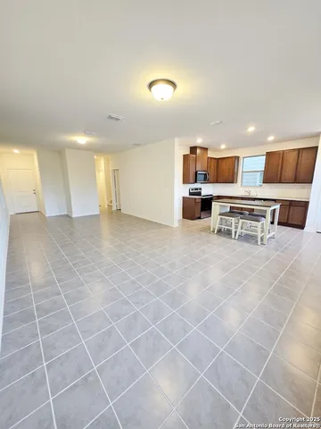 a living room with furniture a rug and a table