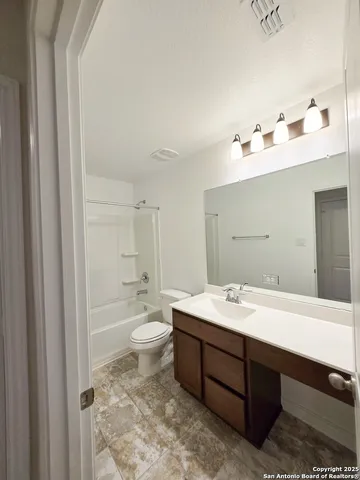 a bathroom with a double vanity sink mirror and toilet
