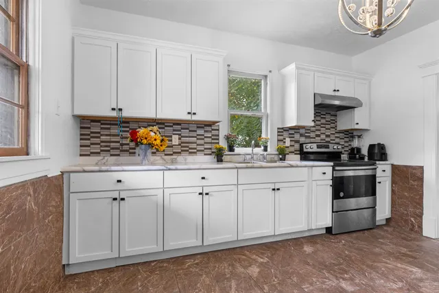 a kitchen with white cabinets and white appliances