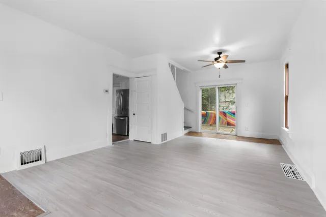 wooden floor in an empty room with a window