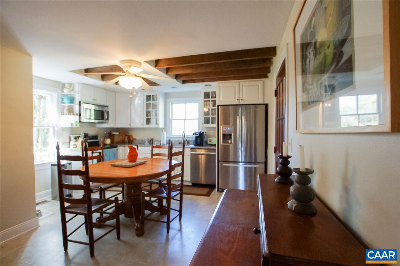 3759 Courthouse Road Louisa, VA 23093 - Photo 7 of 29 a kitchen with stainless steel appliances granite countertop a dining table chairs and granite counter tops