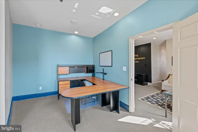 a view of a bedroom with a workspace