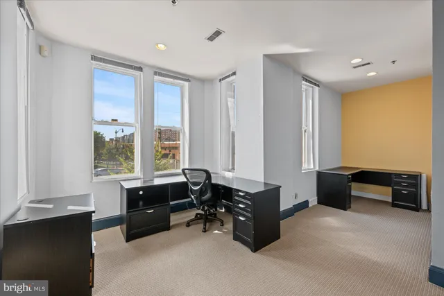 a view of workspace with furniture and windows