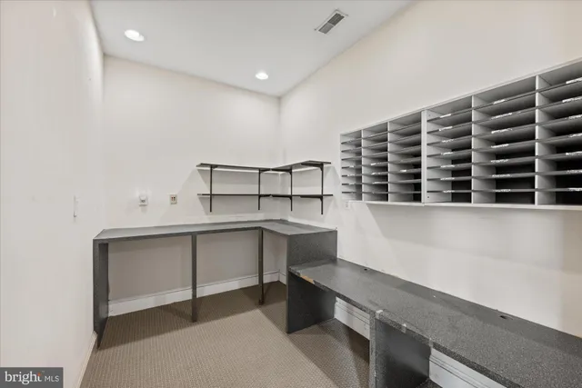 a living room with furniture and large windows