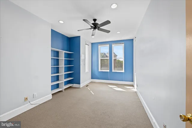 a view of an empty room with a window and closet