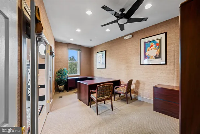 a workspace with furniture and a ceiling fan