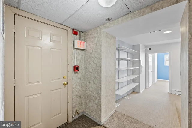 a view of a hallway with seating area
