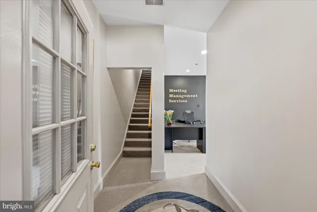 a view of hallway with wooden floor