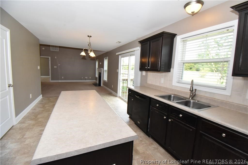 131 South Prince Henry Way Cameron, NC 28326 - Photo 4 of 26 a kitchen with a sink a large window and cabinets