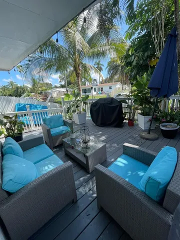 a view of a patio with couches and a potted plant
