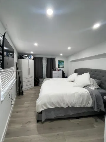 a room with water heater and wooden cabinets
