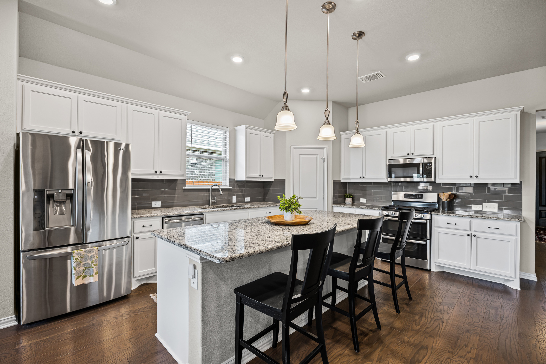 631 Turquoise Drive Dripping Springs, TX 78620 - Photo 4 of 23 Modern kitchen featuring sleek finishes, ample counter space, and seamless flow into the main living areas.