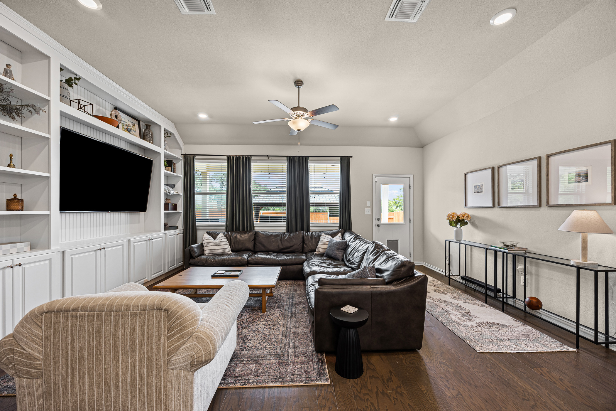631 Turquoise Drive Dripping Springs, TX 78620 - Photo 7 of 23 The living area features built-in shelving, rich hardwood flooring, and recessed lighting